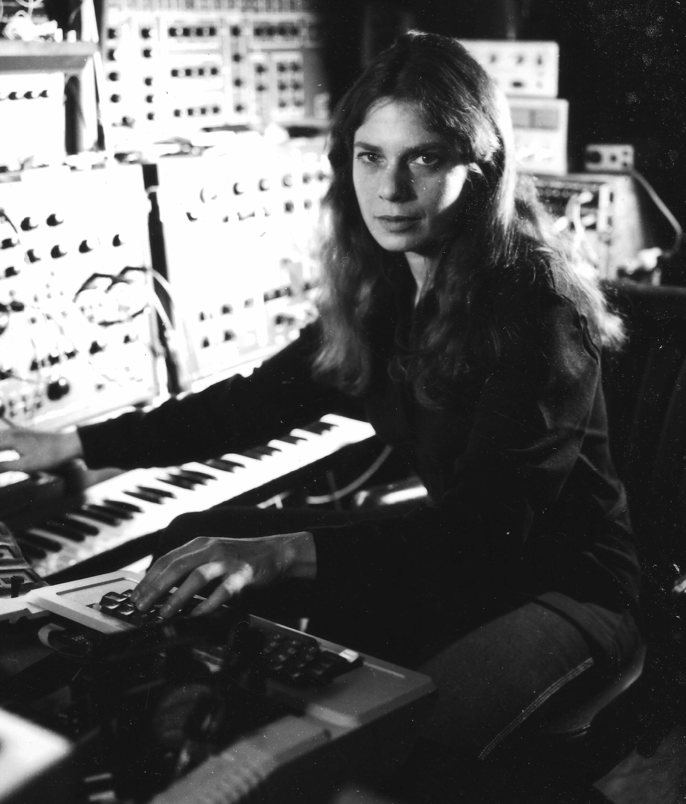 Archival photo of Laurie Speigel in the 70s. She is using a synthesizer.